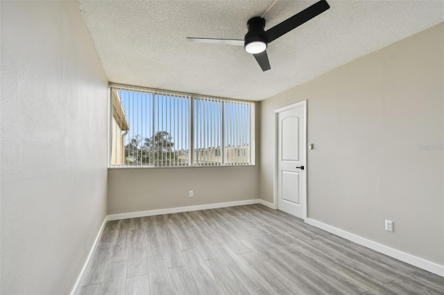 spare room featuring a textured ceiling, ceiling fan, and wood-type flooring