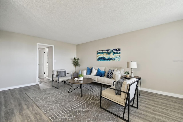 living room featuring dark hardwood / wood-style flooring and a textured ceiling