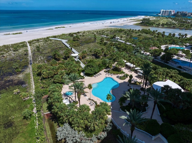 birds eye view of property with a beach view and a water view