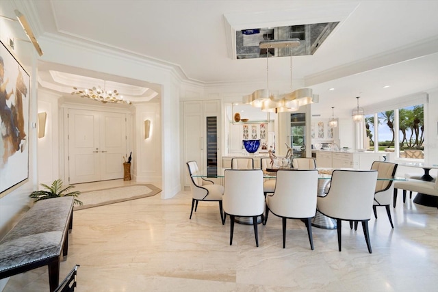 dining area featuring crown molding, an inviting chandelier, and a tray ceiling