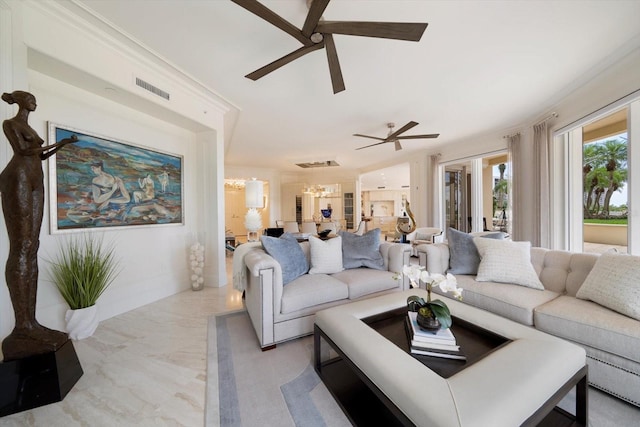 living room with ceiling fan with notable chandelier