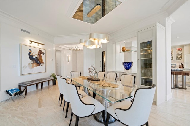 dining space with ornamental molding and a notable chandelier