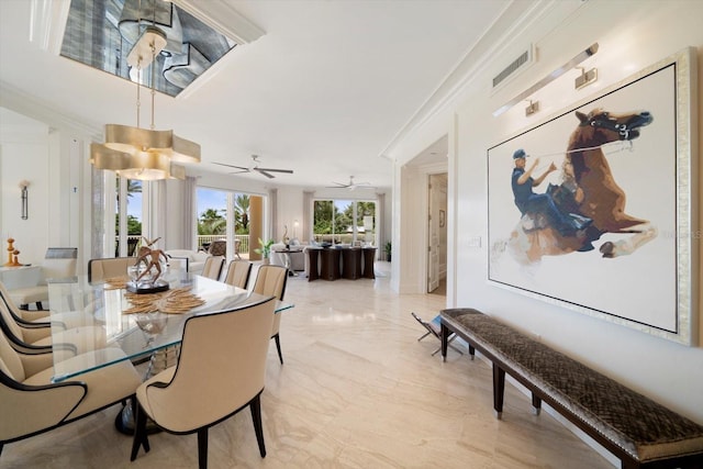 dining space with crown molding and ceiling fan