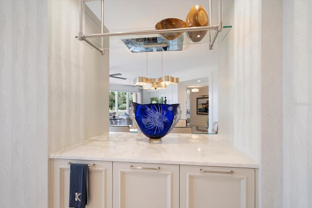 bar with light stone counters and ceiling fan