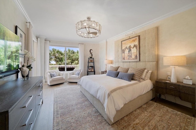 bedroom with crown molding, wood-type flooring, and a chandelier