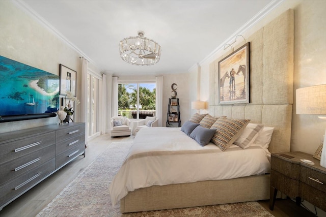 bedroom featuring crown molding, wood-type flooring, and an inviting chandelier