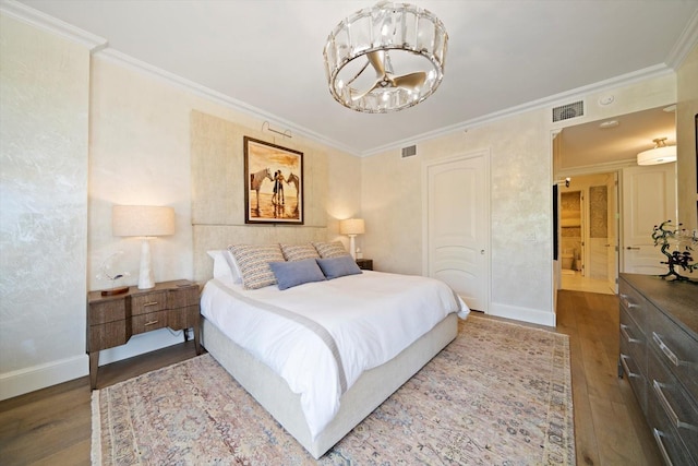 bedroom featuring crown molding, dark wood-type flooring, and a notable chandelier