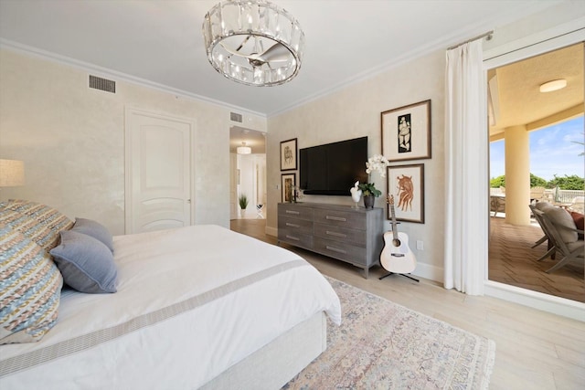 bedroom featuring crown molding, an inviting chandelier, and light hardwood / wood-style floors