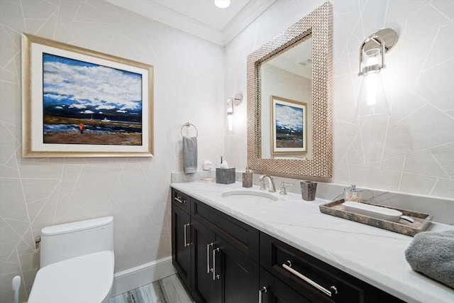 bathroom featuring crown molding, vanity, toilet, and hardwood / wood-style floors