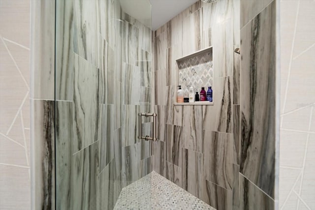 bathroom with tiled shower