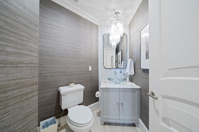 bathroom featuring vanity, toilet, and ornamental molding