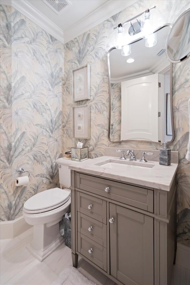 bathroom with ornamental molding, vanity, and toilet