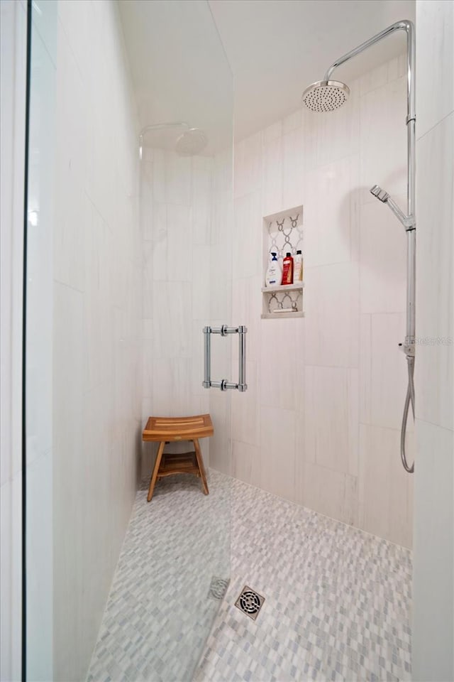 bathroom with tile walls and walk in shower