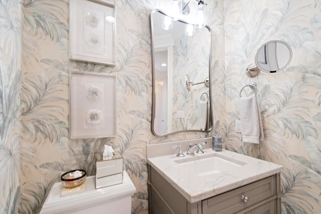 bathroom featuring vanity and toilet