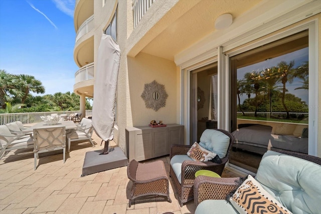 view of patio with a balcony and outdoor lounge area