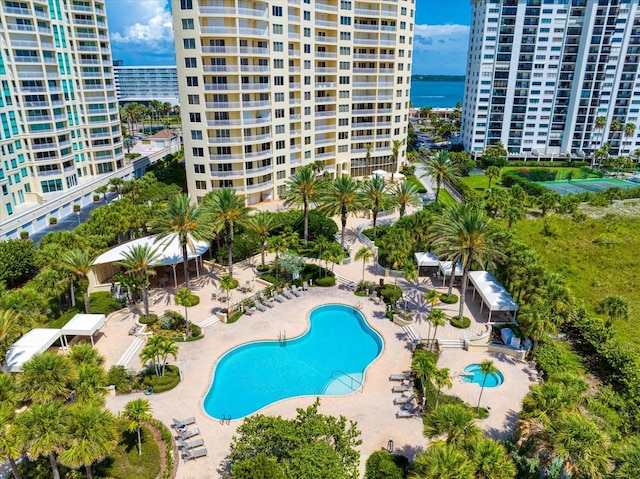 view of pool featuring a patio area and a water view