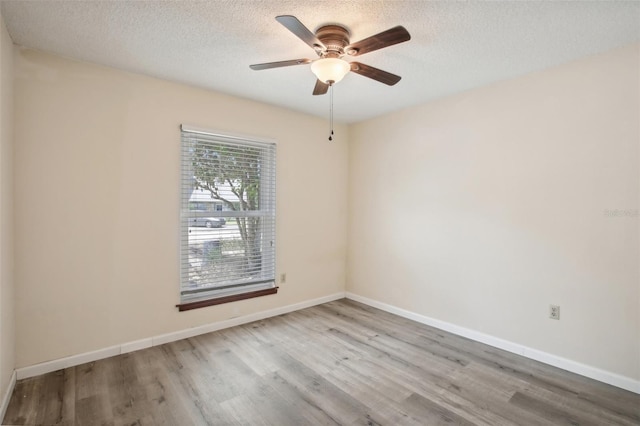 spare room featuring a textured ceiling, ceiling fan, and hardwood / wood-style floors