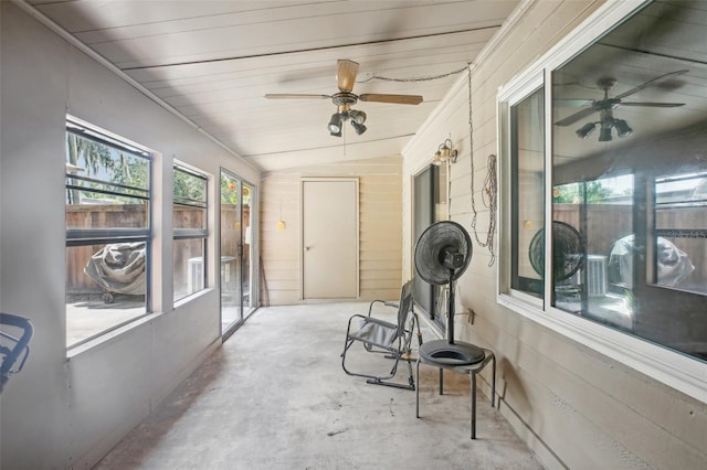 sunroom / solarium with lofted ceiling, ceiling fan, and wooden ceiling