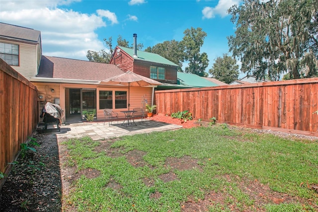 back of property with a lawn and a patio area