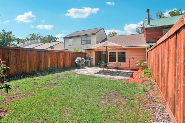 back of property with a yard, central AC, and a patio