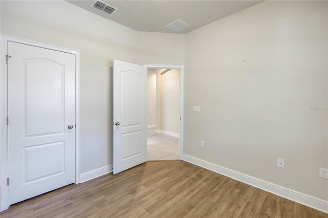 unfurnished bedroom with light wood-type flooring