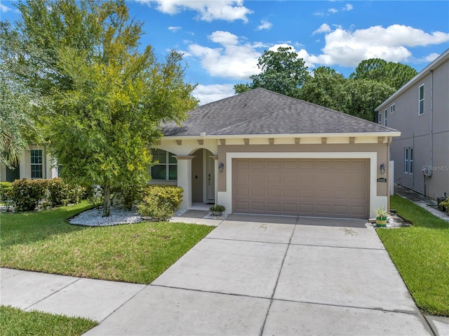 view of front of house with a front lawn and a garage