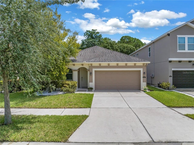 view of front of house with a garage and a front lawn