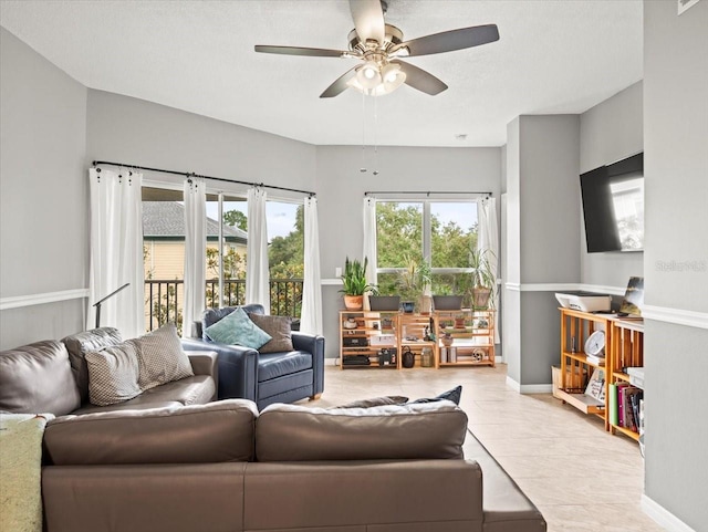 living room with ceiling fan and light tile patterned floors