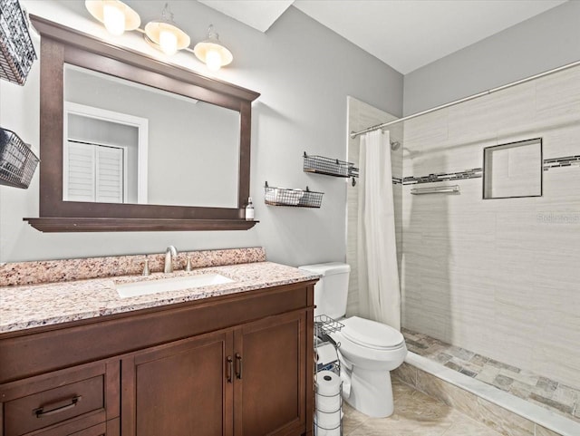 bathroom featuring vanity, toilet, curtained shower, and tile patterned floors