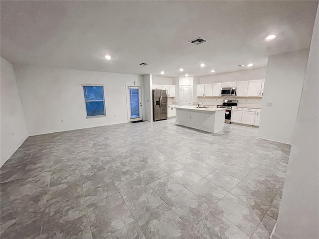 kitchen featuring white cabinetry, a center island, sink, and appliances with stainless steel finishes