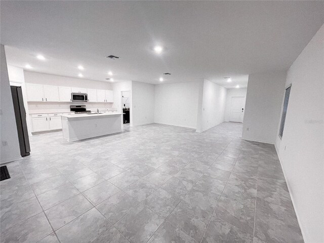 unfurnished living room with sink