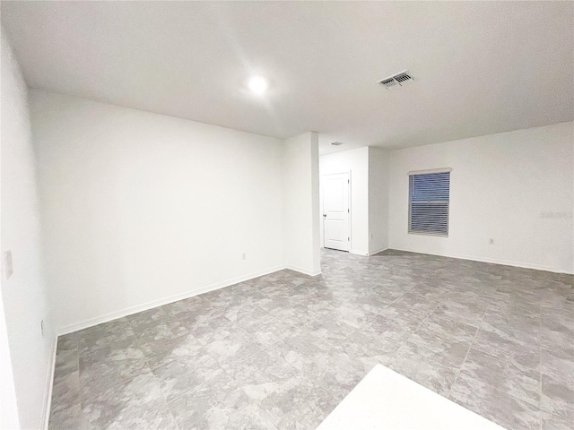 empty room with visible vents and baseboards