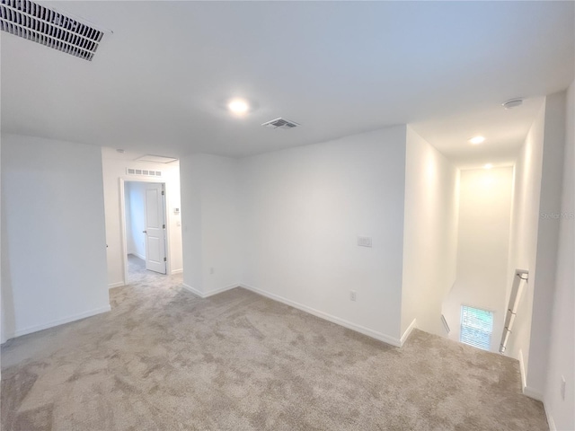 unfurnished room featuring light colored carpet