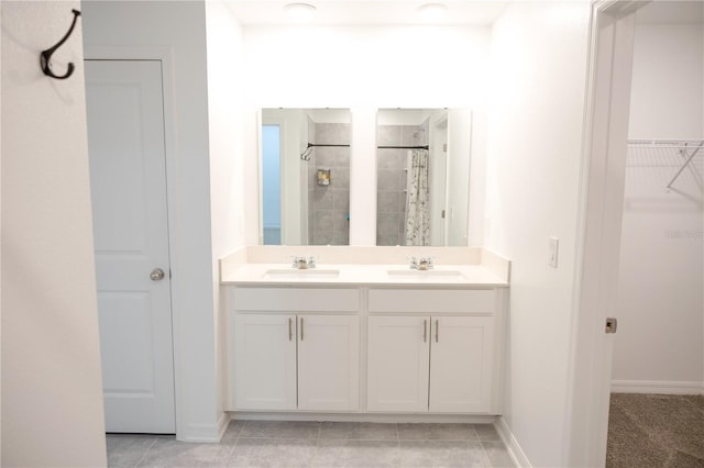 bathroom featuring tile patterned floors, curtained shower, and vanity