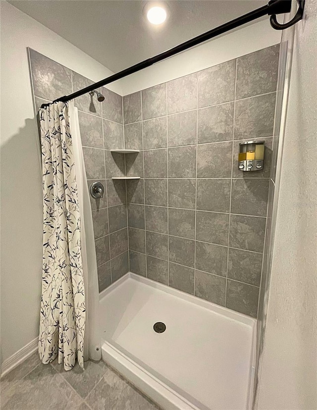 bathroom featuring tile patterned flooring and walk in shower