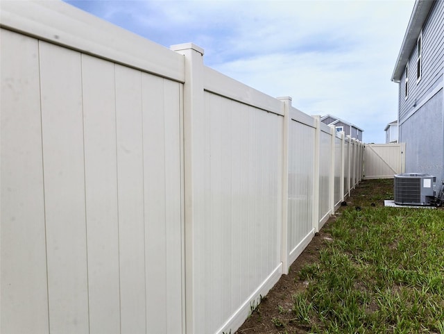 view of yard featuring central air condition unit and fence private yard