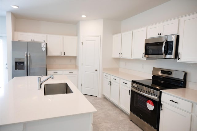 kitchen featuring a sink, white cabinetry, recessed lighting, stainless steel appliances, and light countertops