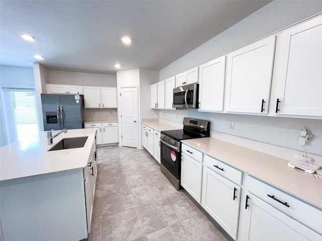 kitchen featuring an island with sink, light countertops, stainless steel appliances, white cabinetry, and a sink