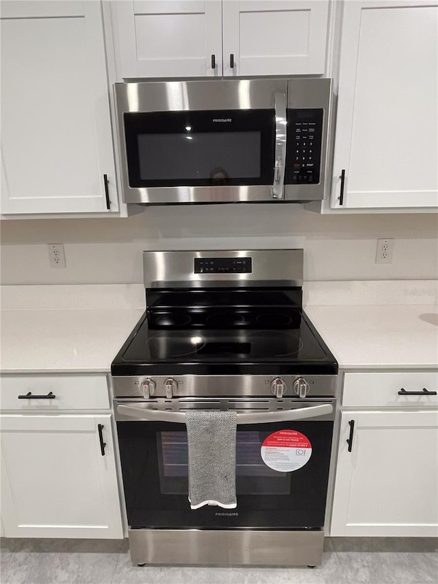 kitchen featuring white cabinetry, light countertops, and appliances with stainless steel finishes