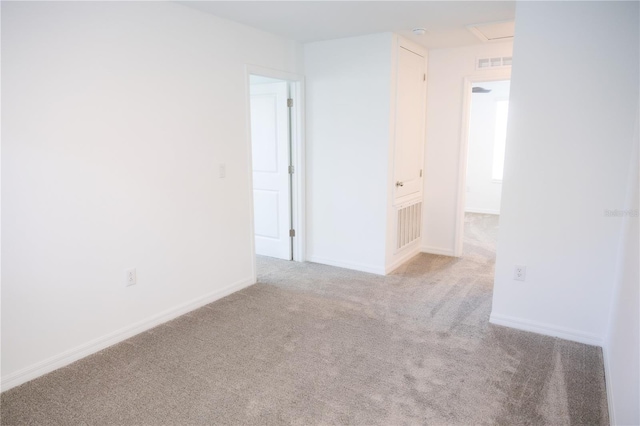 spare room with baseboards, visible vents, and carpet floors