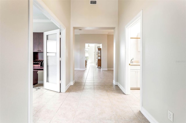 hall with sink and light tile patterned floors