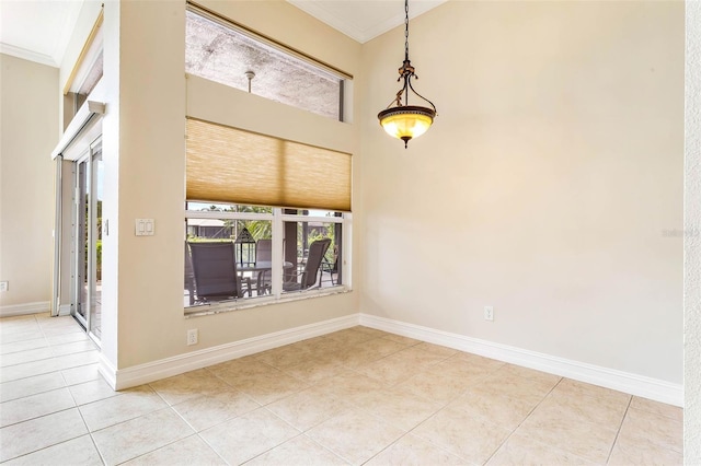 tiled spare room with ornamental molding