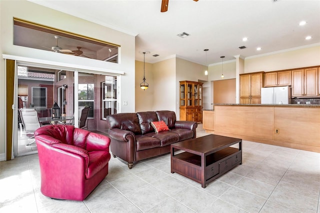 tiled living room with ceiling fan and ornamental molding