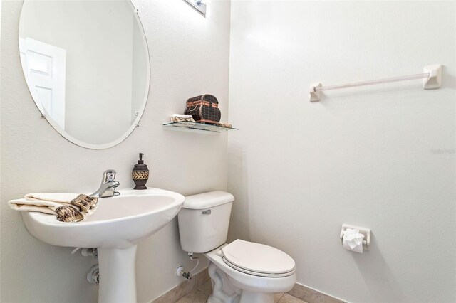 bathroom with tile patterned flooring and toilet