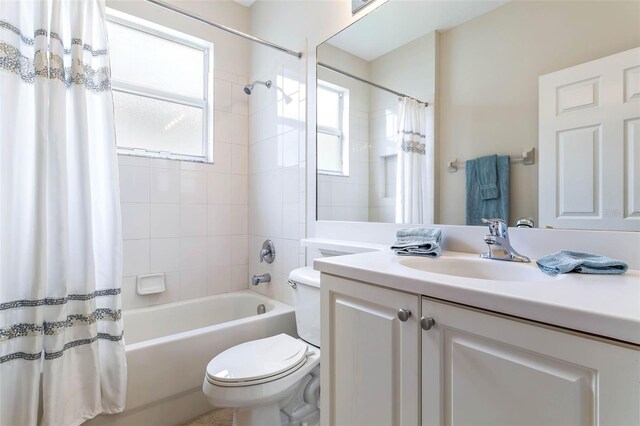 full bathroom with vanity, toilet, and shower / bath combo with shower curtain