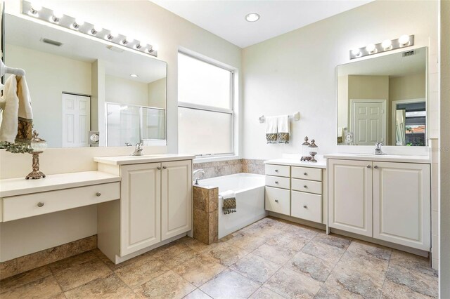 bathroom featuring vanity and separate shower and tub