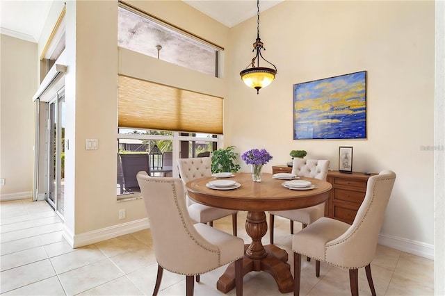 dining room with light tile patterned floors and ornamental molding