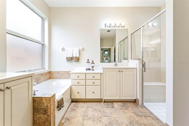 bathroom with vanity and separate shower and tub