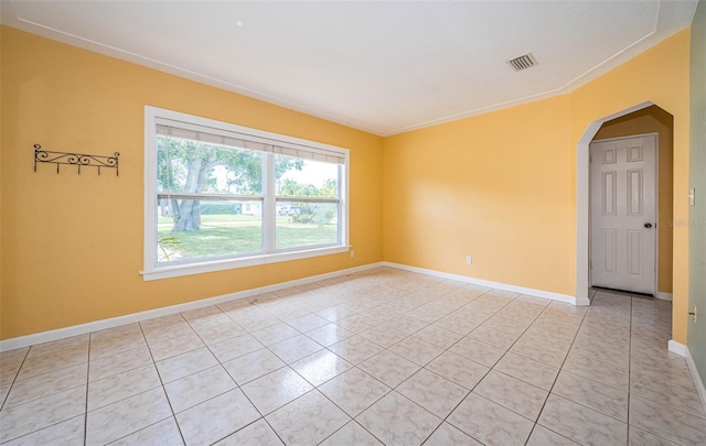 tiled empty room with crown molding