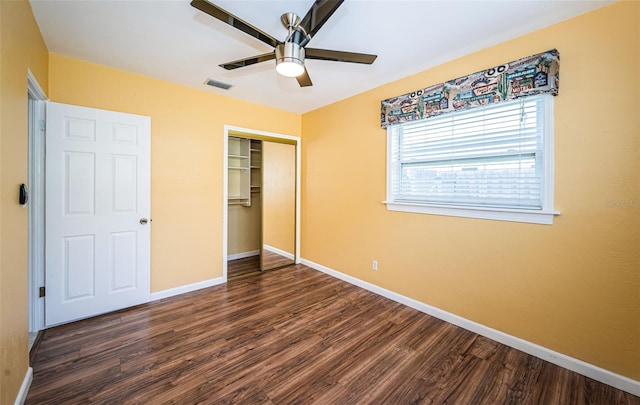 unfurnished bedroom with dark hardwood / wood-style flooring, ceiling fan, and a closet